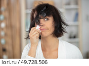 woman with nosebleed at home. Стоковое фото, агентство Ingram Publishing / Фотобанк Лори