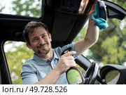 man taking care and cleaning his new car. Стоковое фото, агентство Ingram Publishing / Фотобанк Лори