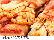 Enoki mushroom appetizer fried in bacon. Asian cuisine. Delicious Japanese dish. Macro. Enoki mushroom appetizer fried in bacon. Стоковое фото, агентство Ingram Publishing / Фотобанк Лори