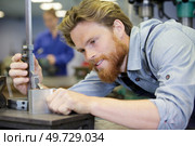 measuring metal parts with vernier caliper. Стоковое фото, агентство Ingram Publishing / Фотобанк Лори