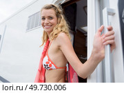happy woman in bikini getting out of her campervan. Стоковое фото, агентство Ingram Publishing / Фотобанк Лори