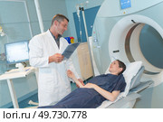 female patient looking at radiologist preparing her for mri scan. Стоковое фото, агентство Ingram Publishing / Фотобанк Лори