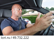 portrait of an angry driver yelling in his car. Стоковое фото, агентство Ingram Publishing / Фотобанк Лори