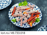 Traditional smoked salami on a plate, meat appetizer.. Salami on a plate, bratwurst sausage. Стоковое фото, агентство Ingram Publishing / Фотобанк Лори