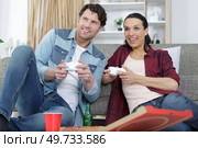 young couple having fun playing videogame at home. Стоковое фото, агентство Ingram Publishing / Фотобанк Лори