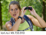 young female using binoculars looking very surprised. Стоковое фото, агентство Ingram Publishing / Фотобанк Лори