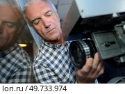cameraman controls focus on television videocamera. Стоковое фото, агентство Ingram Publishing / Фотобанк Лори