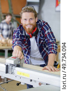 happy carpenter works in a joinery. Стоковое фото, агентство Ingram Publishing / Фотобанк Лори