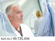 a man stain checking in shirt. Стоковое фото, агентство Ingram Publishing / Фотобанк Лори