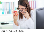woman doctor checks cough remedy. Стоковое фото, агентство Ingram Publishing / Фотобанк Лори