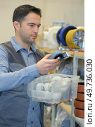 man working at a small wheels factory. Стоковое фото, агентство Ingram Publishing / Фотобанк Лори