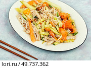 Vegan salad with enoki mushrooms, carrots, cucumber, fried sesame seeds.. Enoki mushroom spicy salad. Стоковое фото, агентство Ingram Publishing / Фотобанк Лори