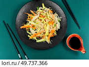 Salad with enoki mushrooms, carrots, cucumber, fried sesame seeds. Enokitake salad. Top view.. Chinese salad with enoki mushrooms. Стоковое фото, агентство Ingram Publishing / Фотобанк Лори