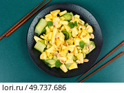 Tasty summer appetizing salad pineapple, ananas, cucumber, nuts salad and chopstick. Flat lay.. Diet pineapple and cucumber salad. Стоковое фото, агентство Ingram Publishing / Фотобанк Лори