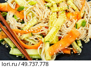 Plate with salad of enoki mushrooms and vegetables. National Chinese food. Flammulina velutipes salad. Close up.. Enoki mushroom spicy salad, macro. Стоковое фото, агентство Ingram Publishing / Фотобанк Лори