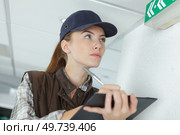 female manufacturing labourer holding clipboard and noting. Стоковое фото, агентство Ingram Publishing / Фотобанк Лори