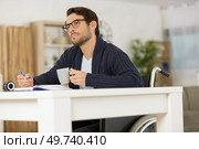 male handicapped writer reflecting what to write. Стоковое фото, агентство Ingram Publishing / Фотобанк Лори