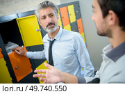 two smartly dressed men in locker room. Стоковое фото, агентство Ingram Publishing / Фотобанк Лори