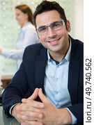 portrait of handsome suited man in an opticians. Стоковое фото, агентство Ingram Publishing / Фотобанк Лори