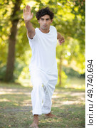 young man practicing traditional chinese tai chi. Стоковое фото, агентство Ingram Publishing / Фотобанк Лори