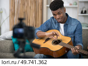 handsome man is recording song. Стоковое фото, агентство Ingram Publishing / Фотобанк Лори