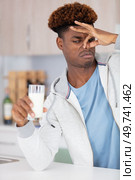 young african-american man with dairy allergy. Стоковое фото, агентство Ingram Publishing / Фотобанк Лори