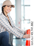 happy female worker holding construction cone. Стоковое фото, агентство Ingram Publishing / Фотобанк Лори
