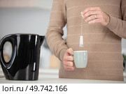 midsection of man preparing some tea. Стоковое фото, агентство Ingram Publishing / Фотобанк Лори