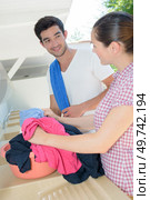 a happy couple handwashing clothes. Стоковое фото, агентство Ingram Publishing / Фотобанк Лори