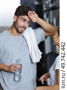 man wiping his sweat with his hand. Стоковое фото, агентство Ingram Publishing / Фотобанк Лори
