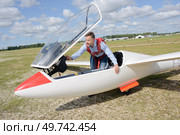 portrait of man getting into glider. Стоковое фото, агентство Ingram Publishing / Фотобанк Лори
