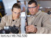 group mechanic engineer turner processes manufacturing steel parts. Стоковое фото, агентство Ingram Publishing / Фотобанк Лори