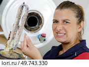 female plumber dealing with lime issue. Стоковое фото, агентство Ingram Publishing / Фотобанк Лори