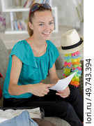 happy woman with laptop preparing travel. Стоковое фото, агентство Ingram Publishing / Фотобанк Лори