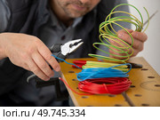 electrician engineer works with electric cable wires. Стоковое фото, агентство Ingram Publishing / Фотобанк Лори
