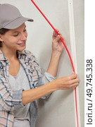 young tradeswoman installing electrical wiring. Стоковое фото, агентство Ingram Publishing / Фотобанк Лори
