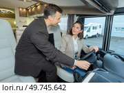Woman being shown controls of campervan. Стоковое фото, агентство Ingram Publishing / Фотобанк Лори