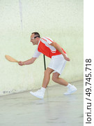 a man is playing pala. Стоковое фото, агентство Ingram Publishing / Фотобанк Лори