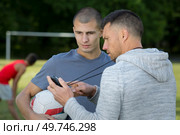 a football coach with footballer. Стоковое фото, агентство Ingram Publishing / Фотобанк Лори