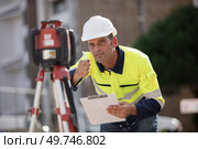surveyor builder worker with theodolite equipment. Стоковое фото, агентство Ingram Publishing / Фотобанк Лори