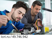 two men repairing a desktop computer. Стоковое фото, агентство Ingram Publishing / Фотобанк Лори