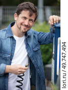 smiling man is inflating a tire. Стоковое фото, агентство Ingram Publishing / Фотобанк Лори