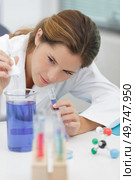 scientist holding 50 ml conical tube with blue liquid solution. Стоковое фото, агентство Ingram Publishing / Фотобанк Лори