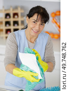 young woman in apron and gloves cleaning office. Стоковое фото, агентство Ingram Publishing / Фотобанк Лори