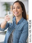 woman holding forwards her healthy glass of milk. Стоковое фото, агентство Ingram Publishing / Фотобанк Лори