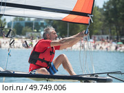 professional waterman training on lake with catamaran. Стоковое фото, агентство Ingram Publishing / Фотобанк Лори