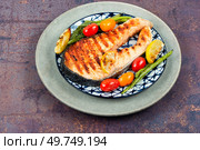 Grilled salmon steak with grilled vegetables, Roasted fish. Ketogenic lunch.. Grilled trout steak on a plate. Стоковое фото, агентство Ingram Publishing / Фотобанк Лори