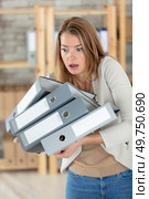 frustrated businesswoman struggling with an armful of office files. Стоковое фото, агентство Ingram Publishing / Фотобанк Лори