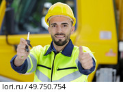 logistics man in front of a container truck with helmet. Стоковое фото, агентство Ingram Publishing / Фотобанк Лори