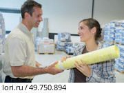 male and female workers analyzing papers in factory. Стоковое фото, агентство Ingram Publishing / Фотобанк Лори